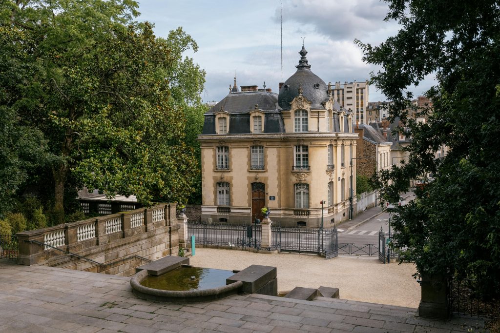 Elegant 19th-century building with garden in the heart of Rennes, France, showcasing classic architecture.